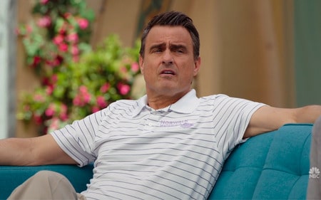 Ben Koldyke is sitting on a couch